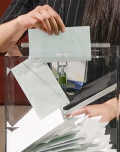ballots being put into a box